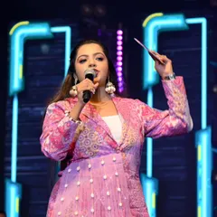 A shot of me on stage in a vibrant pink jacket. This look is perfect for high-energy concerts and festivals where a pop of color helps me stand out on a large stage.