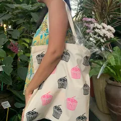 A guest models the tote bag she printed with our cupcake design. Our bags are made from high-quality, organic cotton, making them a durable and stylish keepsake from our community workshops.