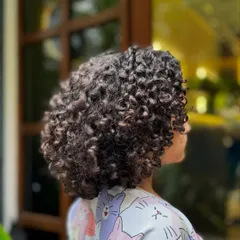 A side view of her cute, bouncy bob. This haircut is easy to maintain and keeps her hair from getting tangled.