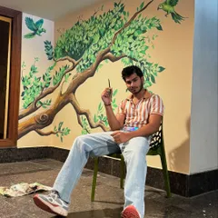 After finishing the parrot mural, taking a moment to see how the art has completely changed the feeling of the space. It's a joy to see a simple wall come alive with color and movement.
