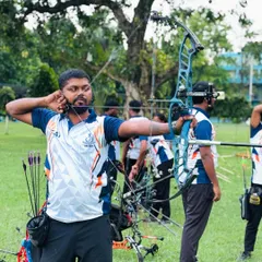 At full draw, demonstrating the anchor point and focus required for consistent accuracy with a compound bow.