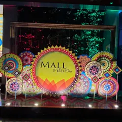 This branded installation for 'Mall FiftyOne' features a central logo display surrounded by colorful, mandala-inspired cutouts. It's an effective way to decorate a commercial space for a launch or promotional event.