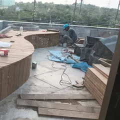 Our team is skilled in crafting custom-built furniture. Here you can see the process of building a curved wooden bench on-site, designed to fit the unique contours of a terrace.