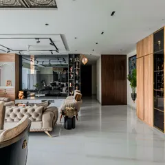 This angle showcases the open-plan layout and the impressive glass-door display cabinet, perfect for showcasing art and decor. The design emphasizes light and space.