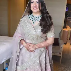 A full view of Priyal's minimalistic and beautiful bridal look. The soft pastel colors of her outfit are complemented by a fresh, glowing makeup application that lets her natural beauty shine.