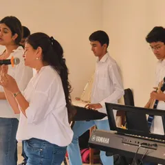 A close-up of our band rehearsing. Our vocal coaches work alongside the instrumentalists to ensure a polished and heartfelt performance, focusing on harmony and dynamics.