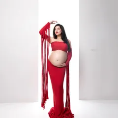 Motherhood is a statement of power and beauty. I love using bold colors and artistic concepts, like this vibrant red maternity look, to create portraits that are as unique and strong as you are.