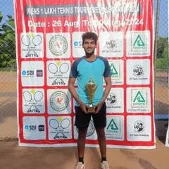 A proud victory for NTC player Maan Kesharwani, holding his trophy after winning the AITA 1 Lakh Men's Singles tournament in Lucknow.