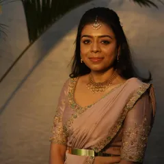 A beautiful portrait of Dr. Tushara. Her custom-designed outfit, paired with traditional jewelry, creates a look of timeless elegance.