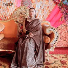 Seated like a queen, this client showcases the elegance of the rented saree. It's a perfect look for a wedding reception or a formal family gathering.