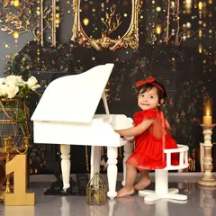 A perfect pose from our glamorous piano-themed shoot. The combination of the white piano, dark background, and golden lights creates a dramatic and beautiful portrait.