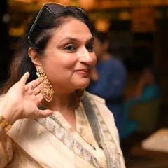 A guest tries on a pair of magnificent chandelier earrings during our exclusive showcase, finding the perfect statement piece for an evening look.