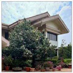 Accented in terracotta roof tiles, this Tuscan-style residence in Khandala is home to tri-level garden terraces with views of the hills. The design is both rustic and grand, fitting for its location.