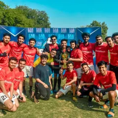 Champions! This corporate team celebrates their victory, taking home the trophy and office bragging rights.