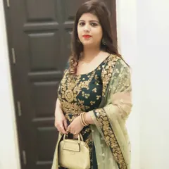 A client looking elegant in a dark green Anarkali suit with heavy gold embroidery. This is a perfect rental outfit for a wedding reception or a festive family gathering.