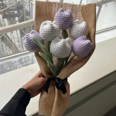 Simple, clean, and elegant. This bouquet features our classic closed tulips in alternating lavender and white, wrapped in rustic burlap with a simple black ribbon.