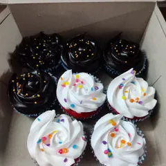 A classic combination of chocolate and vanilla cupcakes. The chocolate ones have a rich ganache with gold sprinkles, and the red velvet cupcakes have a simple vanilla buttercream with rainbow sprinkles.