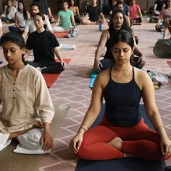 A moment of shared stillness and meditation during a group practice. This is where we quiet the mind after the physical work, connecting to the deeper benefits of yoga.