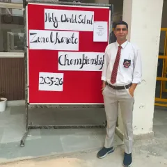 At the Zonal Karate Championship hosted at Holy World School. I am there to coach and support my students.
