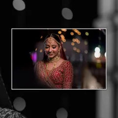 This image captures the serene beauty of a bride adorned in her custom Rianza wedding jewellery. The intricate gold choker and matching matha patti are designed to be cherished for generations.