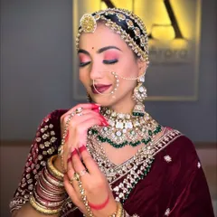 A closer look at the eye makeup for our royal bride. The pink and red tones on the eyes complement the velvet lehenga, while the defined brows and sharp liner add to the regal feel.