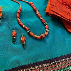 A beautiful coral and turquoise bead necklace set, designed by me. This piece adds a pop of color to my 30-year-old classic Kanjeevaram saree.