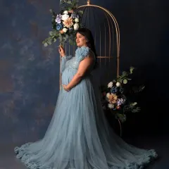 For the mama who wants to feel like a queen. In my studio, we create these elegant, glamorous portraits with flowing gowns and artistic setups like this floral cage, celebrating your strength and beauty in this powerful chapter.
