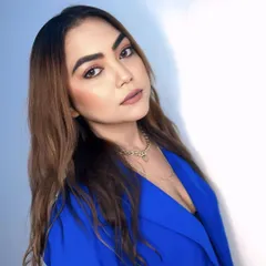 A simple, confident headshot in a vibrant blue blazer.