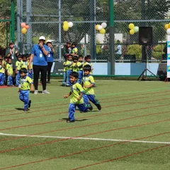The thrill of the race. Young athletes from SNN School give it their all in a running event on our well-maintained turf, perfect for children's sports.