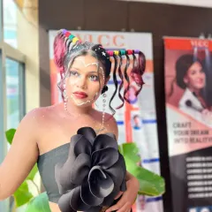 An example of creative, fantasy makeup from my students. This look features intricate facial gems, glitter, and a unique hairstyle, pushing the boundaries of conventional beauty.