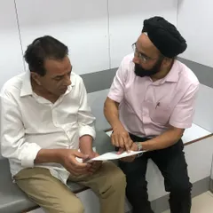 A candid moment discussing a treatment plan. My process always begins with a detailed, honest consultation to understand your goals and explain what is medically possible.
