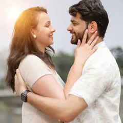 A happy, natural portrait of a couple sharing a smile. This close-up captures their genuine joy and connection.