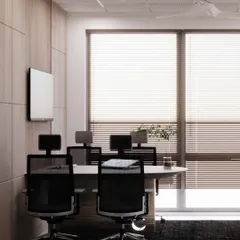 This view of a conference room shows how we use natural light and clean design to create a bright and airy workspace. The wood paneling adds warmth and texture to the professional setting.