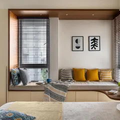 A cozy bay window from one of our projects, showcasing a comfortable seating area with colorful cushions. This is a signature element we love to incorporate for quiet, sunlit moments.