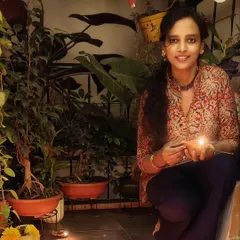 A quiet moment holding a diya during the Karthigai Deepam festival, surrounded by my plants.