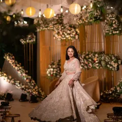 A beautiful twirl on the dance floor. The bride looks radiant in her sparkling lehenga against the stunning floral decor of her engagement ceremony.