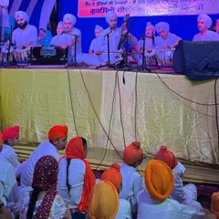The Kirtan Group of Khalsa Music Academy students performing for an audience.