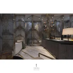 The dramatic, dark marble with gold veining clads the walls of this bathroom, creating a moody and luxurious atmosphere. The custom vanity includes open shelving with integrated lighting for displaying toiletries.