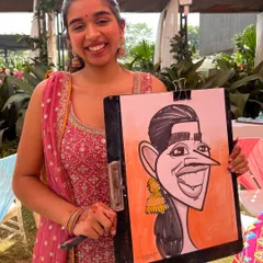 All smiles at a beautiful outdoor wedding event at Radisson Blu, Lonavala. A live sketch is a great way to entertain guests while they mingle during the festivities.