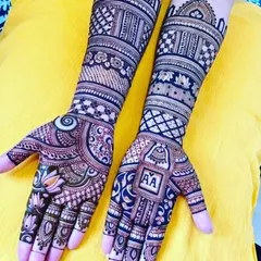 This design cleverly incorporates the initials 'AA' into a traditional pattern on the palm. The arms feature a mix of modern geometric checks and classic floral bands.