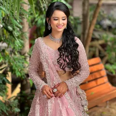 A full shot of the engagement look, showing the beautiful lehenga and the half-up, half-down hairstyle.