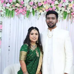 The happy couple at their engagement. Her makeup is soft and radiant, complementing his classic white outfit perfectly.
