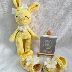 A sunny yellow themed gift set, including a pair of daisy-adorned baby sandals and a matching yellow bunny doll. It's a perfect gift for a summer baby.