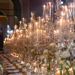A close-up of the magnificent tablescape, featuring rows of crystal candelabras that cast a glittering, romantic light across the entire table.