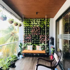A complete balcony transformation in Bangalore. This finished project features a custom living wall with varied plant textures, creating a perfect backdrop for a relaxing swing seat and turning the space into a private urban oasis.