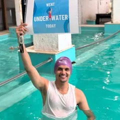 This swimmer is beaming with pride after successfully going underwater for the first time. We celebrate every small victory on the journey to becoming a confident swimmer.