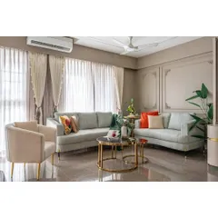 This angle showcases the harmonious layout of the living area, featuring plush sofas, a nested coffee table, and ample natural light. We use classic design principles to create spaces that feel both timeless and contemporary.