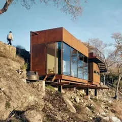A stunning example of a container home built on a rocky cliffside. We find and develop properties in unique locations just a few hours from major cities, offering a peaceful haven and a smart investment.
