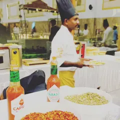 A glimpse of our live pizza station, complete with a variety of fresh toppings and seasonings. We use professional ovens to serve perfectly cooked vegetarian pizzas.
