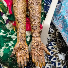 A complete view of a full bridal design on both arms. One arm features more floral and circular motifs, while the other incorporates geometric grids, showing how we can mix styles.